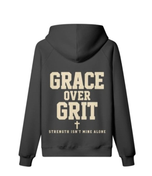 Back view of black oversized hoodie with cream Grace Over Grit lettering, cross, and Strength Isn't Mine Alone text